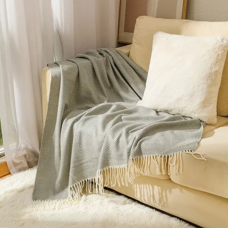 Cotton sofa throw with striped pattern and fringes