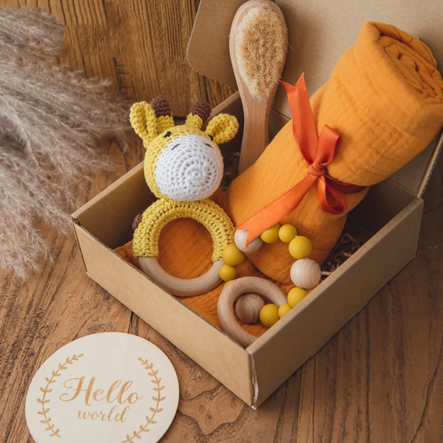 Baby gift box with muslin blanket and crocheted toy